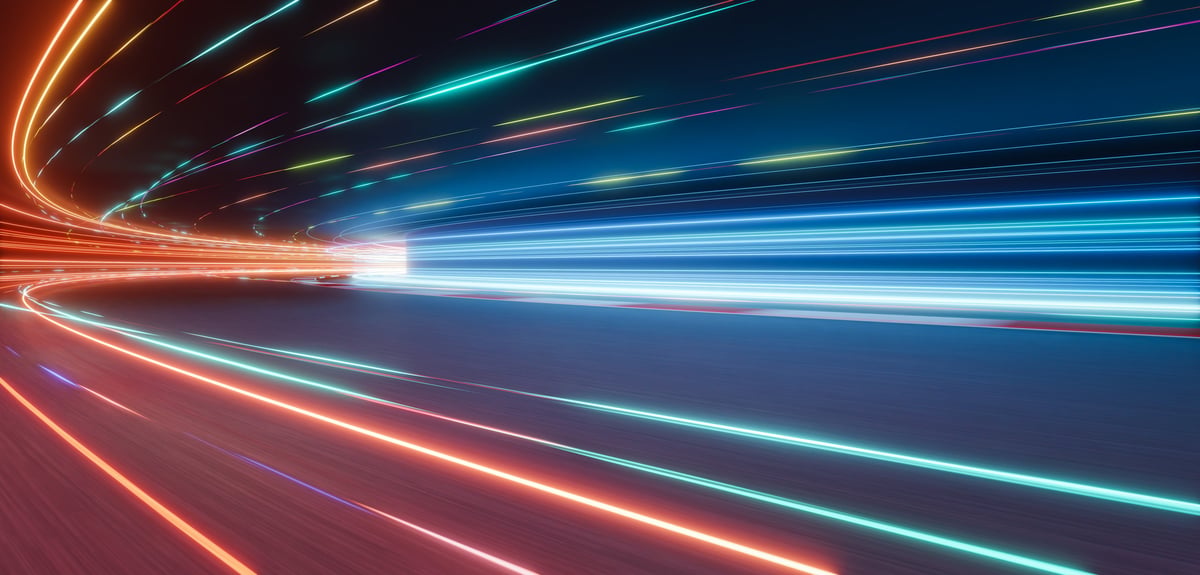 Colorful light trails on a night racing circuit